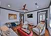 The living room has seating for everyone, a smart tv, and desk space if you need to catch up on work.
