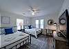 The second bedroom has two queen beds, a desk, and tv as well as a bathroom down the hall.