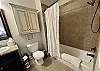 The first bathroom has a tub shower.