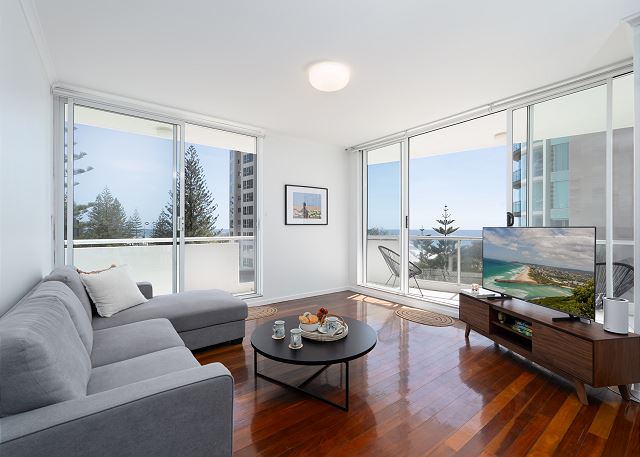 Relax in this bright, breezy and open plan living room with smart TV and beach and ocean views. 