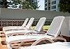 Relax with a good book around the pool on a sun lounge.