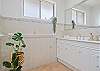 Wide vanity, walk in shower with pull down shower seat and grab rails.