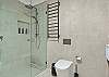 Walk in shower, heated towel rail, toilet, vanity and washing machine.