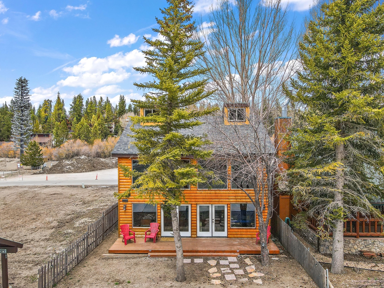 Front of home with trees right on Moonridge Rd with coffee shops and WALK to BEAR MOUNTAIN SHUTTLE