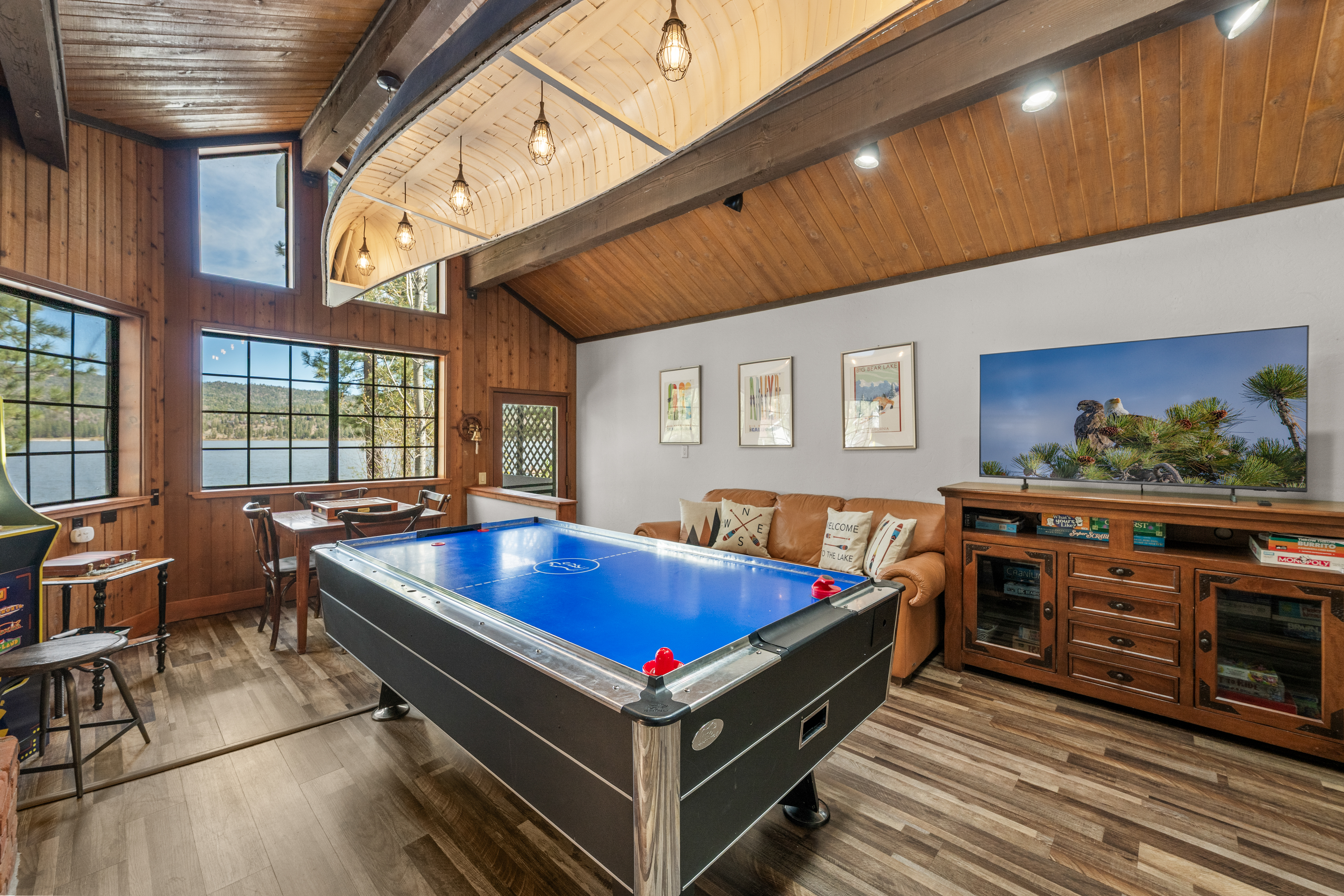 Game Room with Air Hockey, PacMan arcade, smart TV, canoe chandelier, Fireplace, and beautiful lake views inside and out with a private balcony!