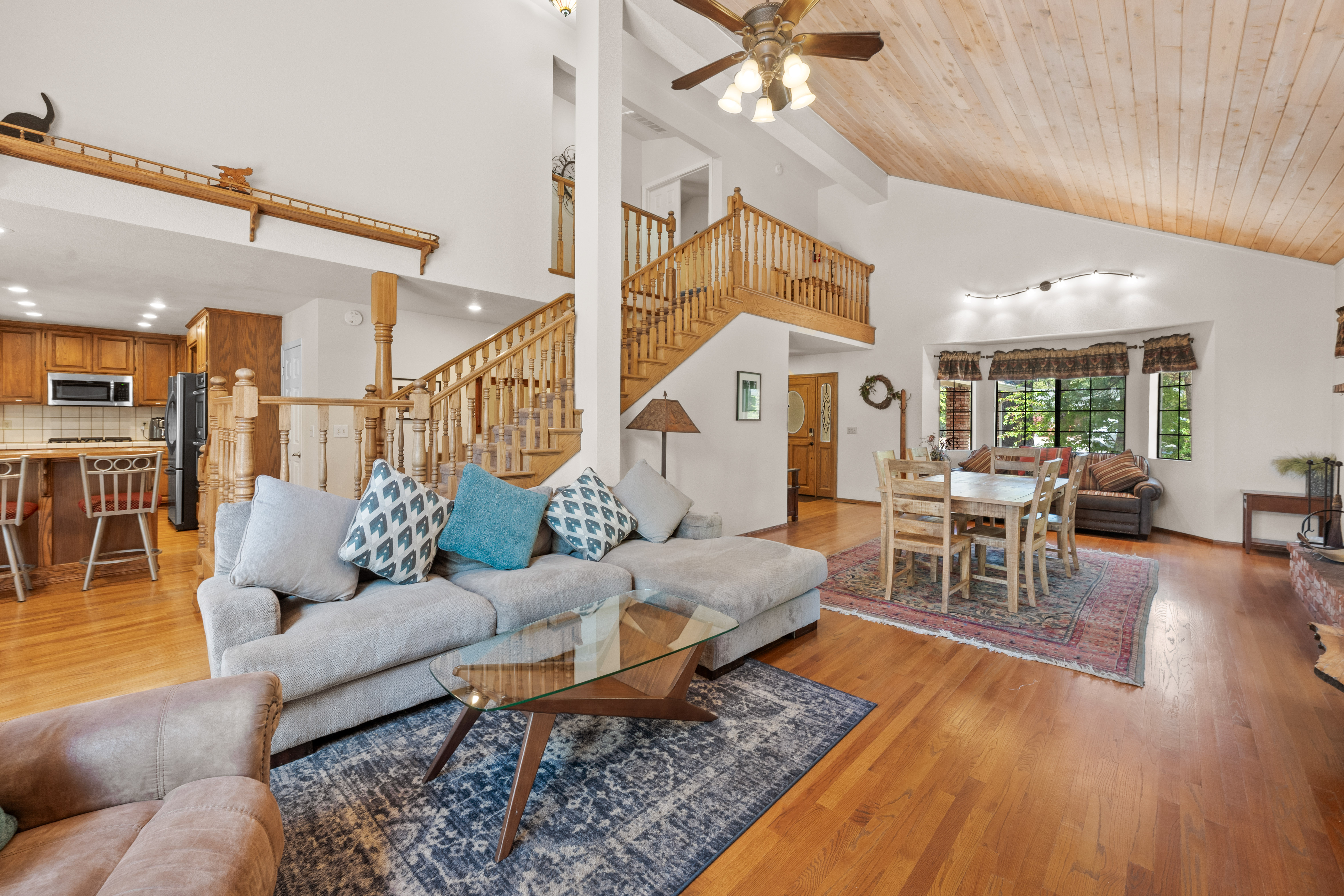 The spacious living area is ideal for relaxing after a day on the slopes or lake, featuring a plush sectional, smart TV, and large windows that fill the space with natural light.