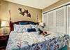 Enjoy this king size bed and the tropical linens