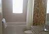 First floor bath for twin beds and additional half bath downstairs for guests
