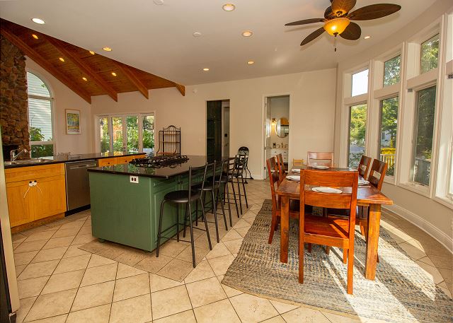 Main level full kitchen with dining for eight. Extra seating at 