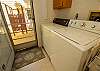Main level washer and dryer with a door to the back deck and gri Main level washer and dryer with a door to the back deck and gri