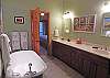 Main Level Master Bath with Double Sinks, free-standing Tub and separate Shower.