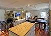 View of Kitchen, Dining and Family Room. Family Room has gas fireplace, flat screen Smart TV and plenty of seating