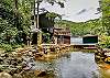 TimberCove Cottage private pond creates the sound of a waterfall as it empties into Lake Lure