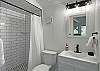 New Bath with walk-in shower serves the King Bedroom and Main Level Living Areas.