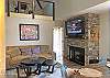 Family Room features gas fireplace, flat screen TV and comfy seating.