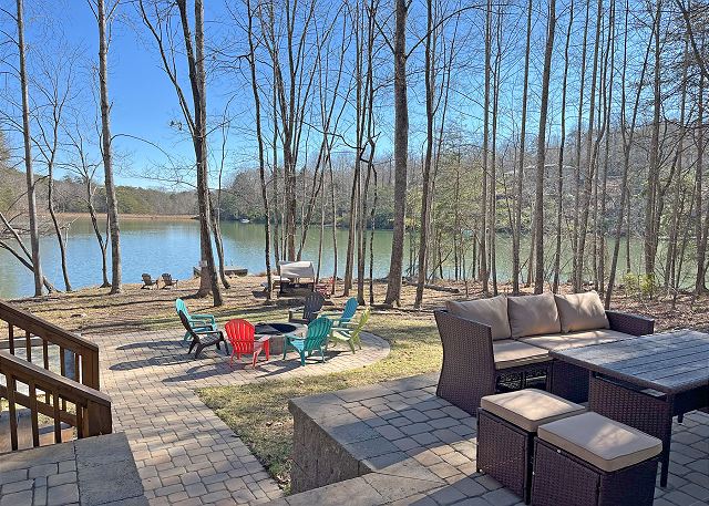 Welcome to Serenity Cove - A peaceful mountain lakefront home in Rumbling Bald.  Wonderful outdoor spaces include private dock and watercraft, fire pit area, outdoor seating...