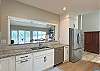 Double sink,Stainless French door fridge, and Dishwasher all with a peaceful view of Lake Lure.