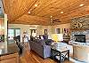 Spacious Main Level Great Room has gas fireplace, Large smart TV, and access to Deck and Hot Tub.  Main floor has open floor plan with Kitchen and Dining Area to the left.