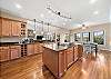 Spacious Kitchen is well equipped for cooking for large gatherings.  Kitchen opens onto Great Room, and Dining Area table with 8 chairs.