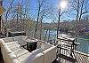 Large Deck overlooks the lake, has lots of comfy seating, Hot Tub, propane firepit table, and a Blackstone Grill