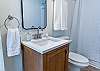 Admire the elegance of the mirror and sink in our beautifully appointed Downstairs Bathroom, where you can refresh and prepare for the day in style. - Downstairs Bathroom