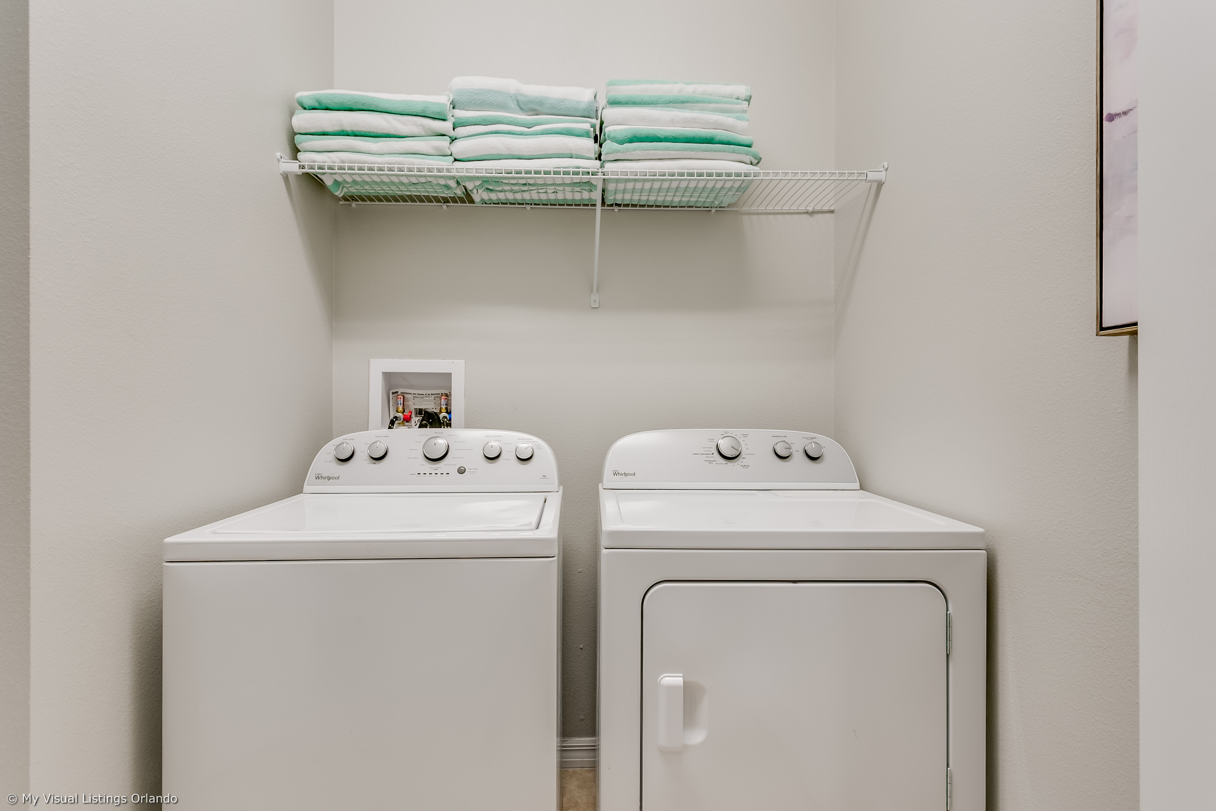 Convenient laundry room with full size washer and dryer with tow