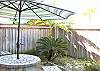 Quaint private fenced in backyard with patio table. Perfect for an evening meal outdoors!