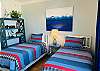 Nautical bedding and decor bring life at the sea into the double twin bedroom