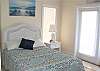 Full-sized bedroom with doors out to a small front balcony
