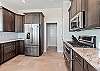 High end SS appliances, custom cabinetry and marble countertops