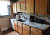 Full Kitchen with Refrigerator, Dishwasher, Stove, Microwave, Granite Counter Tops and Coffee Pot 