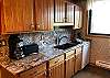 Full Kitchen with Refrigerator, Stove, Dishwasher, Microwave, and Granite Counter Tops