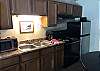 Full Kitchen with Microwave, Full Size Stove, and Refrigerator. Coffee Pot