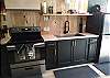 Luxurious black cabinets with wooden counter tops