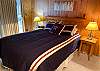 Lower Level Queen Bed Room with Slider Door to Out Door Shared Hot Tub