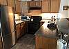 Full Kitchen with Refrigerator, Stove, Dishwasher, Microwave, and Coffee Pot