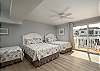 Bedroom 2 - on kitchen level, on South side an/or right as you're facing the street. Has 3 beds (full, queen, and twin)