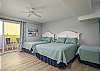 Bedroom 1 - on kitchen level, on North side an/or right as you're facing the street. Has 3 beds (full, queen, and twin)