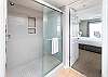 A huge shower enclosed by glass doors.  