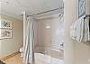 A spacious master bath featuring a shower/tub combo.