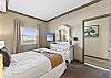 This bedroom has a TV & a window for more sunlight.