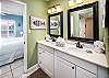 The updated vanity area of the bathroom provides a bright and clean look.