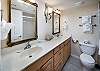 Beautifully decorated bathroom with double sinks with personal mirrors.