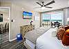 Contains private balcony access and a mounted flat screen TV
