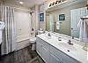 Large vanity featuring two sinks.