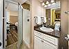 The Guest Bathroom has full facilities, including one sink and a stand-up shower stall. 