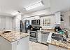 Stainless steel appliances, white cabinetry, endless counter space 