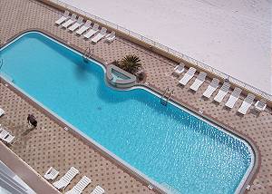 Our 80 foot heated swimming pool is beachside! The deck has ample space for basking in the warm Florida sun. (NOT A VIEW FROM THE UNIT)