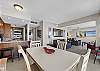 The dining room table is located next to the kitchen for your convenience.