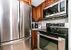Stainless steel appliances and beautiful wooden cabinetry 